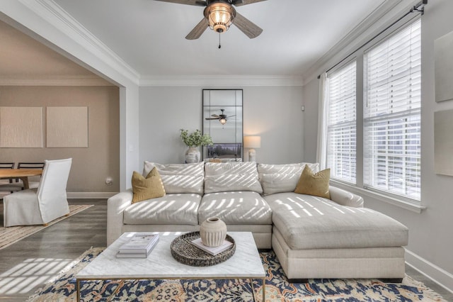 living room with crown molding, ceiling fan, and wood-type flooring