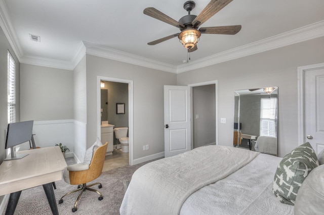 carpeted bedroom featuring ornamental molding, ceiling fan, and ensuite bathroom