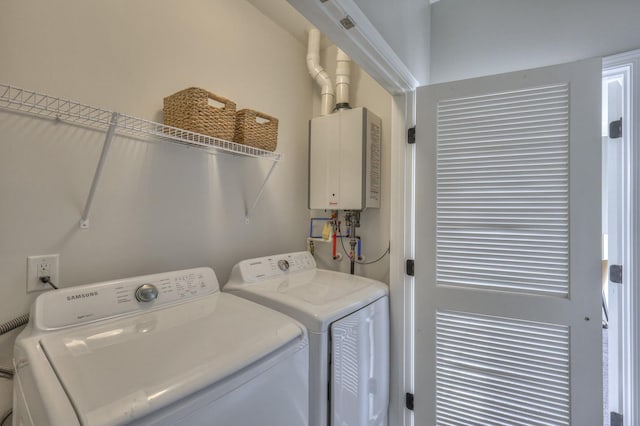 laundry area with separate washer and dryer and water heater