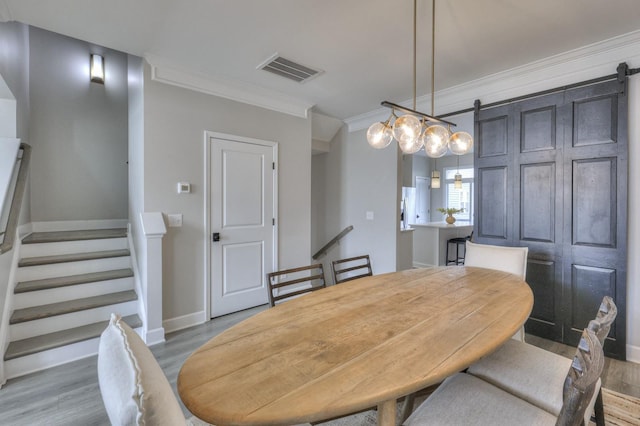 dining space featuring crown molding and hardwood / wood-style floors