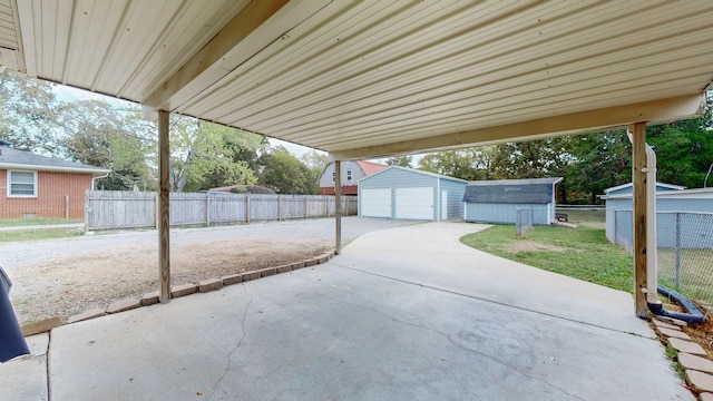 view of patio featuring a garage and a storage unit