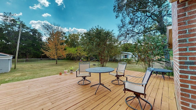 wooden terrace with a yard