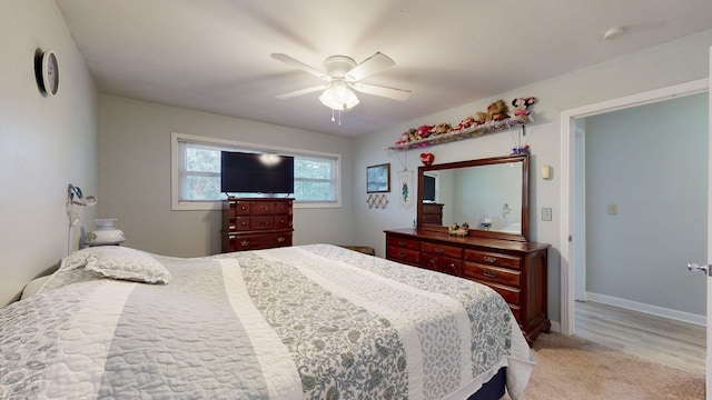 bedroom featuring light carpet and ceiling fan