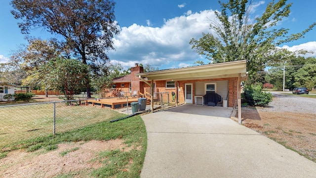 single story home with a front yard and a carport