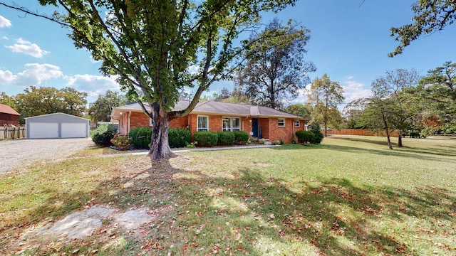 ranch-style house with a garage, an outdoor structure, and a front yard