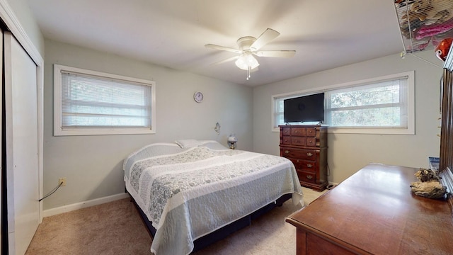 bedroom with a closet, ceiling fan, and carpet flooring