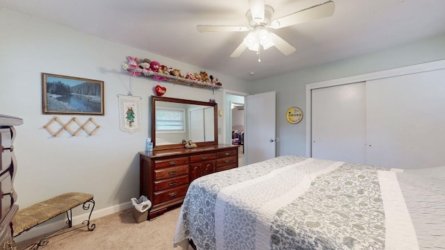 carpeted bedroom with ceiling fan and a closet