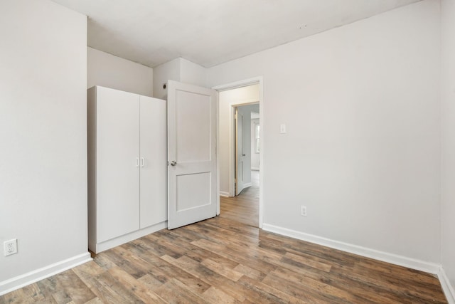 unfurnished bedroom with wood-type flooring