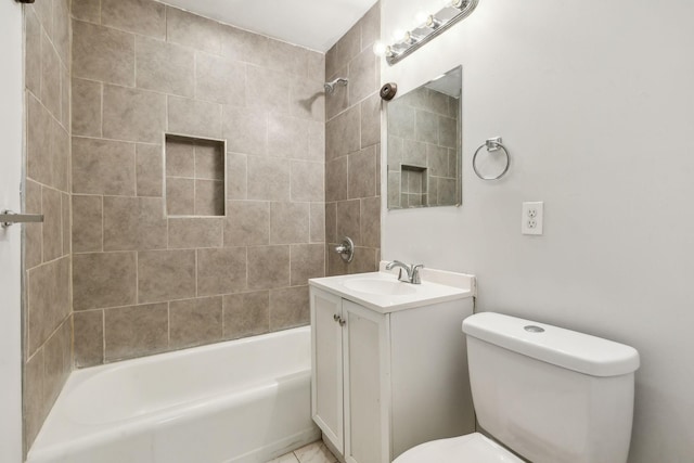 full bathroom with toilet, vanity, and tiled shower / bath