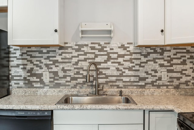 kitchen with sink, black dishwasher, backsplash, white cabinetry, and light stone countertops