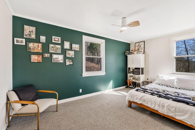 carpeted bedroom with crown molding and ceiling fan