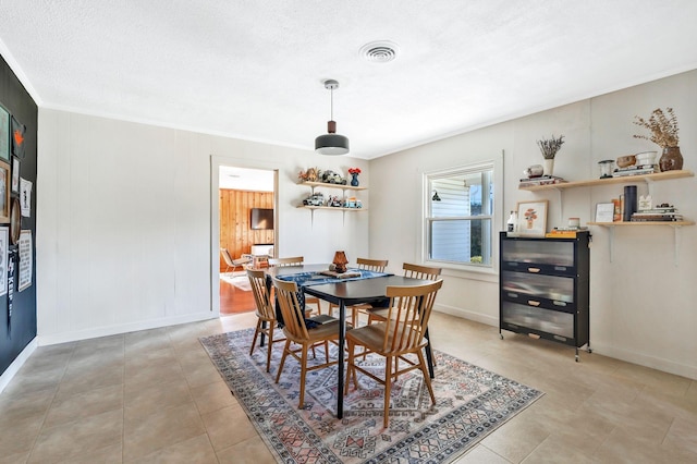 tiled dining space with crown molding