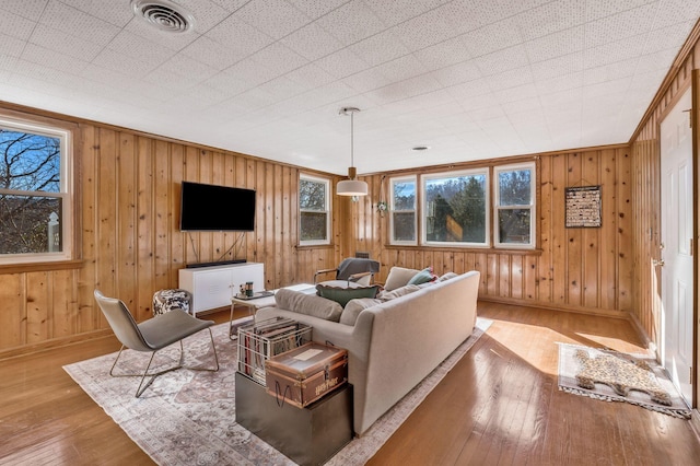 living room with a wealth of natural light and light hardwood / wood-style floors