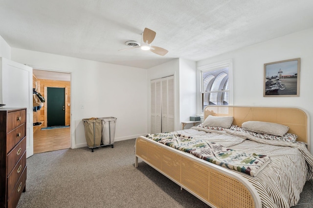 bedroom featuring ceiling fan, a closet, a textured ceiling, and carpet