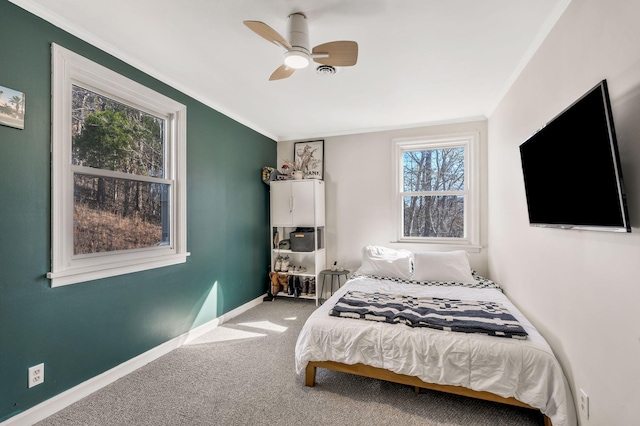 bedroom with crown molding, carpet floors, and ceiling fan