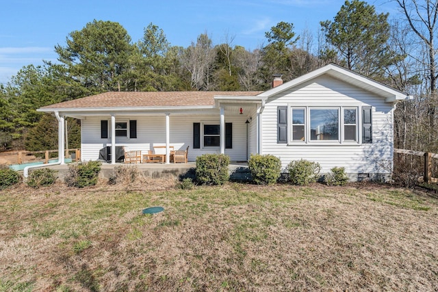 single story home with a front lawn and covered porch