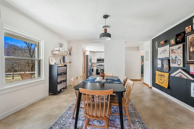 dining area featuring a textured ceiling