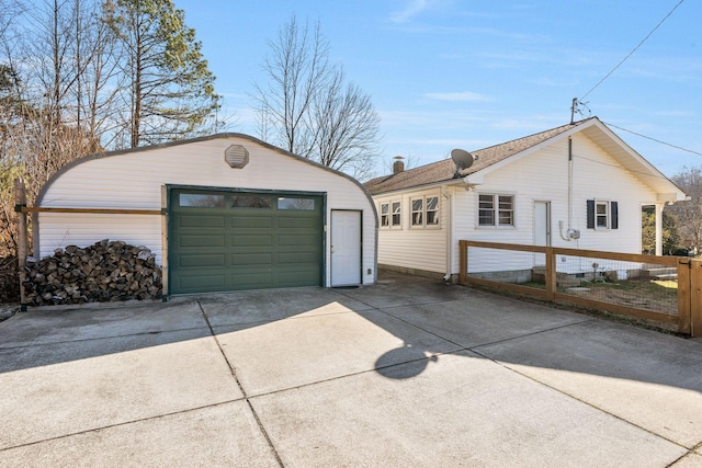 view of property exterior featuring a garage and an outdoor structure