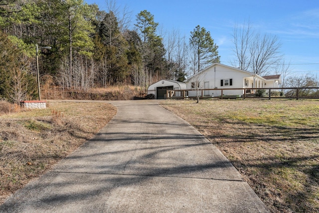 exterior space with a garage and an outbuilding