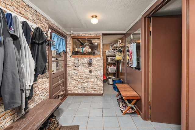 mudroom featuring crown molding and a textured ceiling