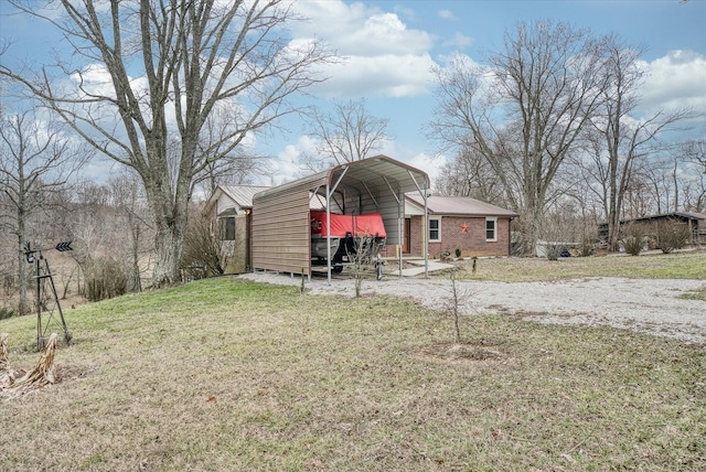 exterior space with a carport and a yard