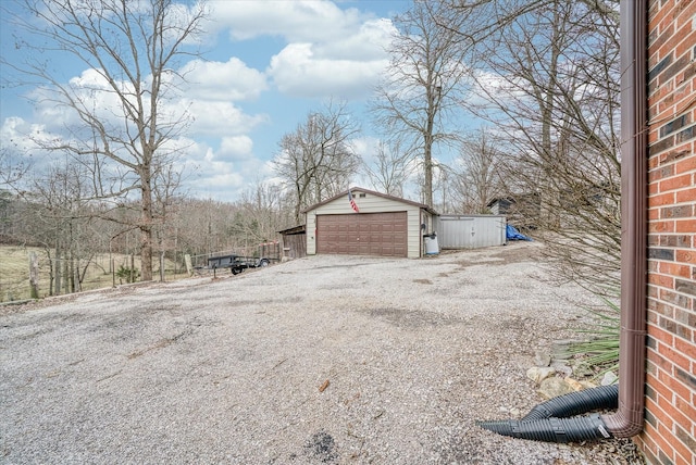 view of property exterior with a garage and an outdoor structure