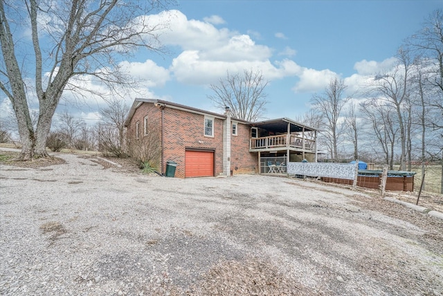 back of property featuring a garage and a balcony