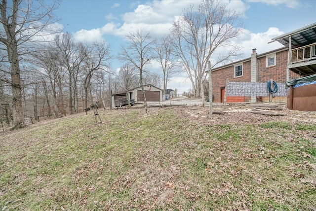 view of yard featuring an outbuilding and a garage