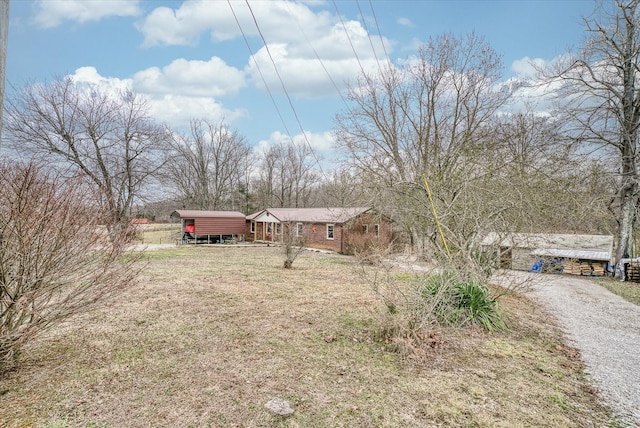 view of front of home with a front yard and a carport