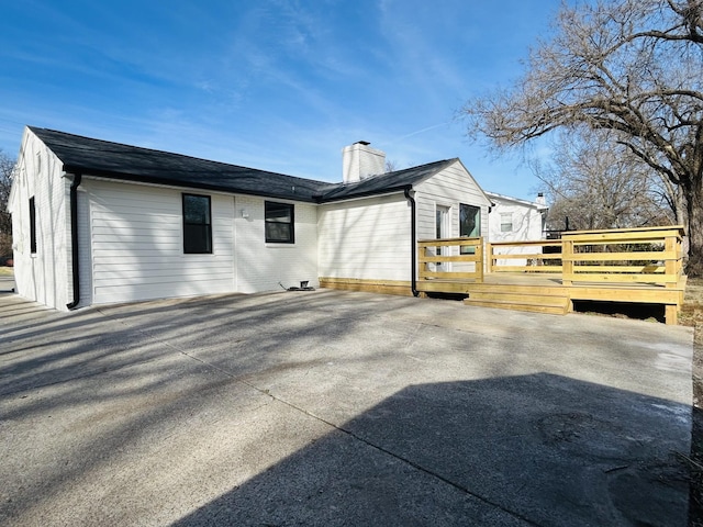 view of side of property with a wooden deck