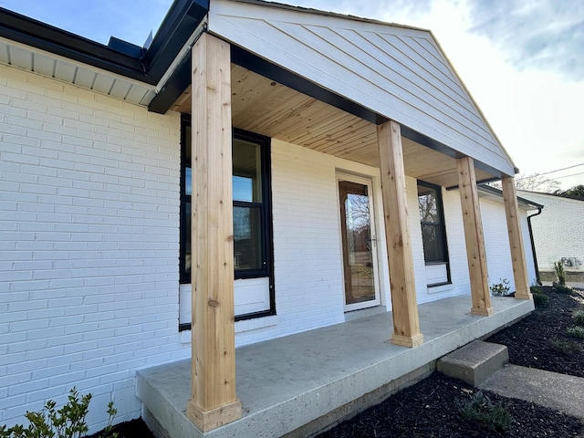 view of exterior entry with covered porch