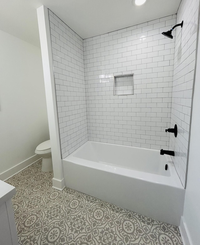 full bathroom with tile patterned floors, vanity, toilet, and tiled shower / bath combo