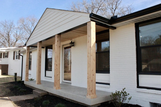 view of exterior entry with covered porch