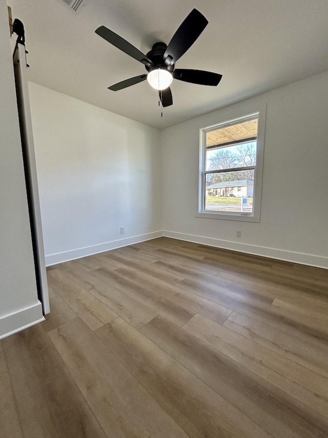 spare room with ceiling fan and light hardwood / wood-style flooring