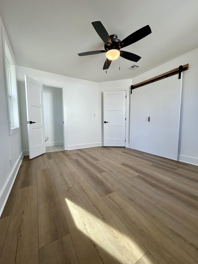 unfurnished bedroom featuring ceiling fan and light hardwood / wood-style flooring