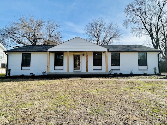 view of front of house with a front lawn, central air condition unit, and covered porch