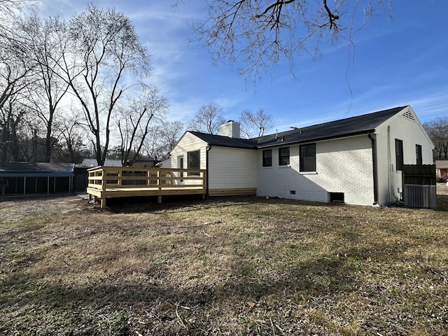 rear view of property featuring a yard, central air condition unit, and a deck