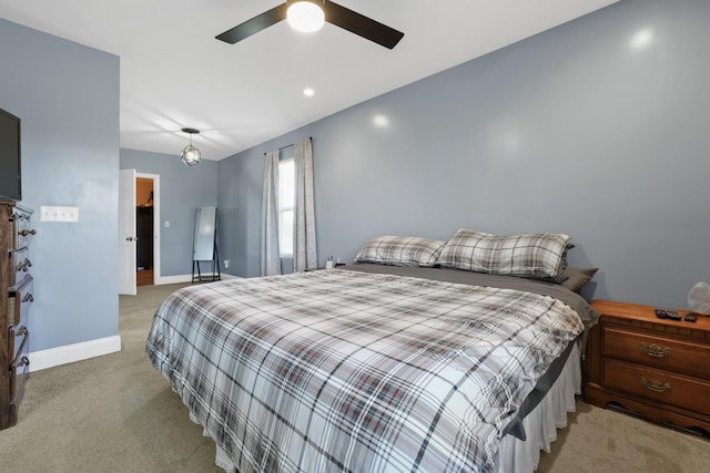 bedroom with ceiling fan and light colored carpet