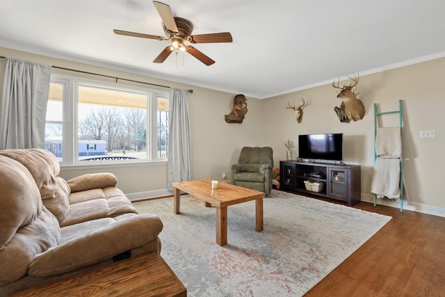 living room with hardwood / wood-style flooring, ceiling fan, and ornamental molding