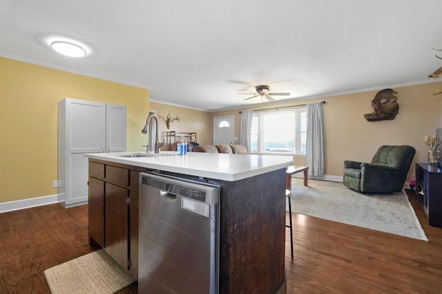 kitchen featuring an island with sink, sink, dark brown cabinets, and stainless steel dishwasher