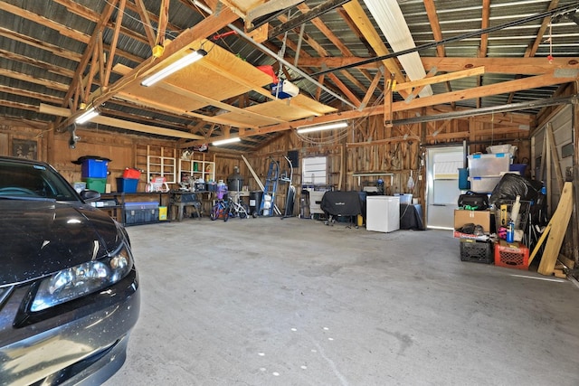 garage with a garage door opener and washer / clothes dryer