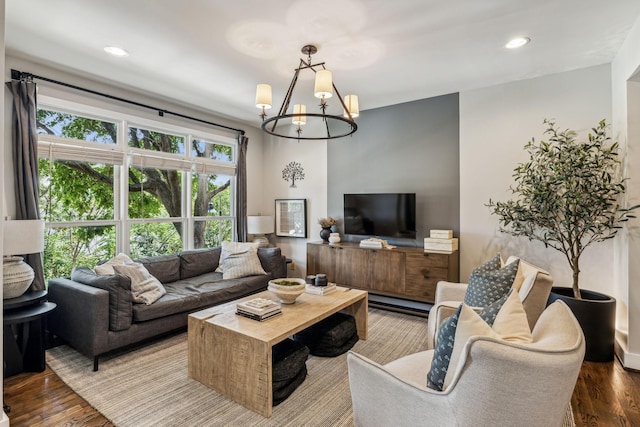 living room with an inviting chandelier and hardwood / wood-style floors