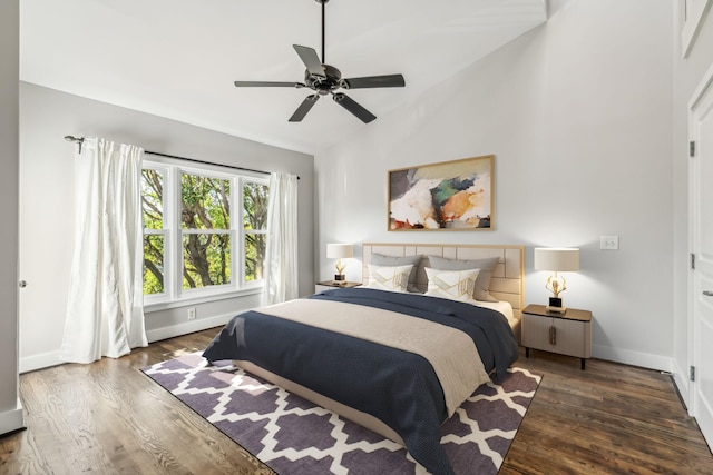 bedroom featuring vaulted ceiling, dark hardwood / wood-style floors, and ceiling fan