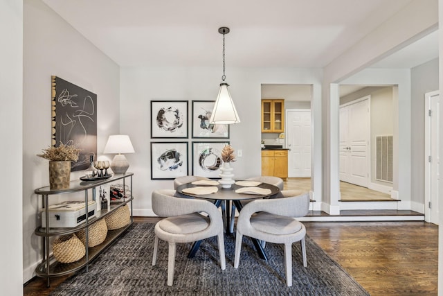 dining area with dark hardwood / wood-style flooring