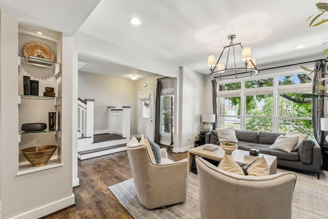 living room featuring dark wood-type flooring and a chandelier