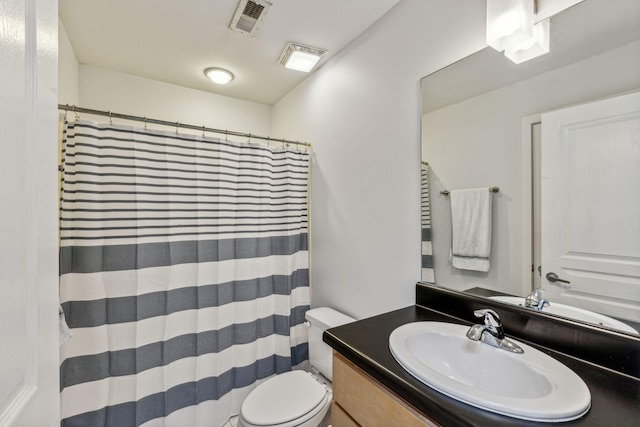 bathroom with walk in shower, vanity, and toilet