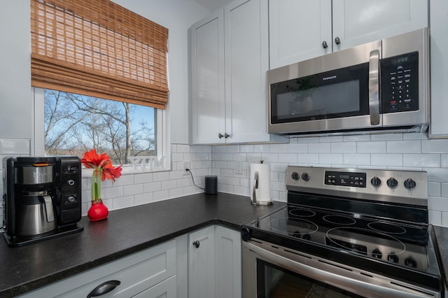 kitchen featuring white cabinetry, appliances with stainless steel finishes, and decorative backsplash