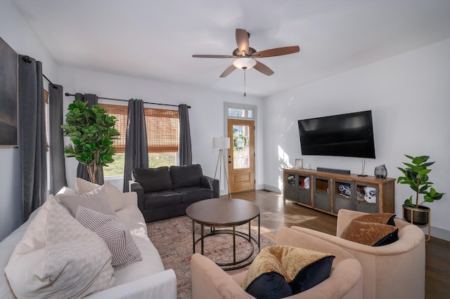 living room with dark wood-type flooring and ceiling fan