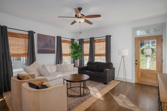 living room with ceiling fan and dark hardwood / wood-style flooring