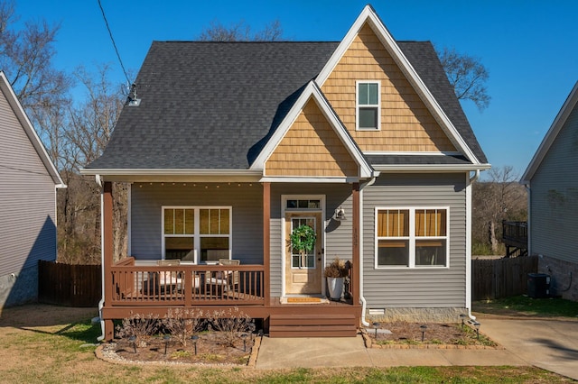 rear view of property with a porch and central air condition unit